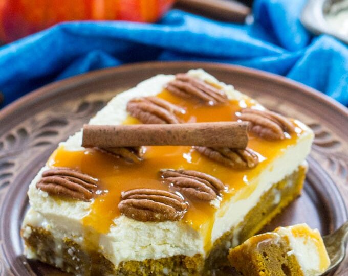White Chocolate Pumpkin Poke Cake is deliciously infused with a sweet white chocolate sauce, topped with cream cheese frosting, caramel and crunchy pecans.