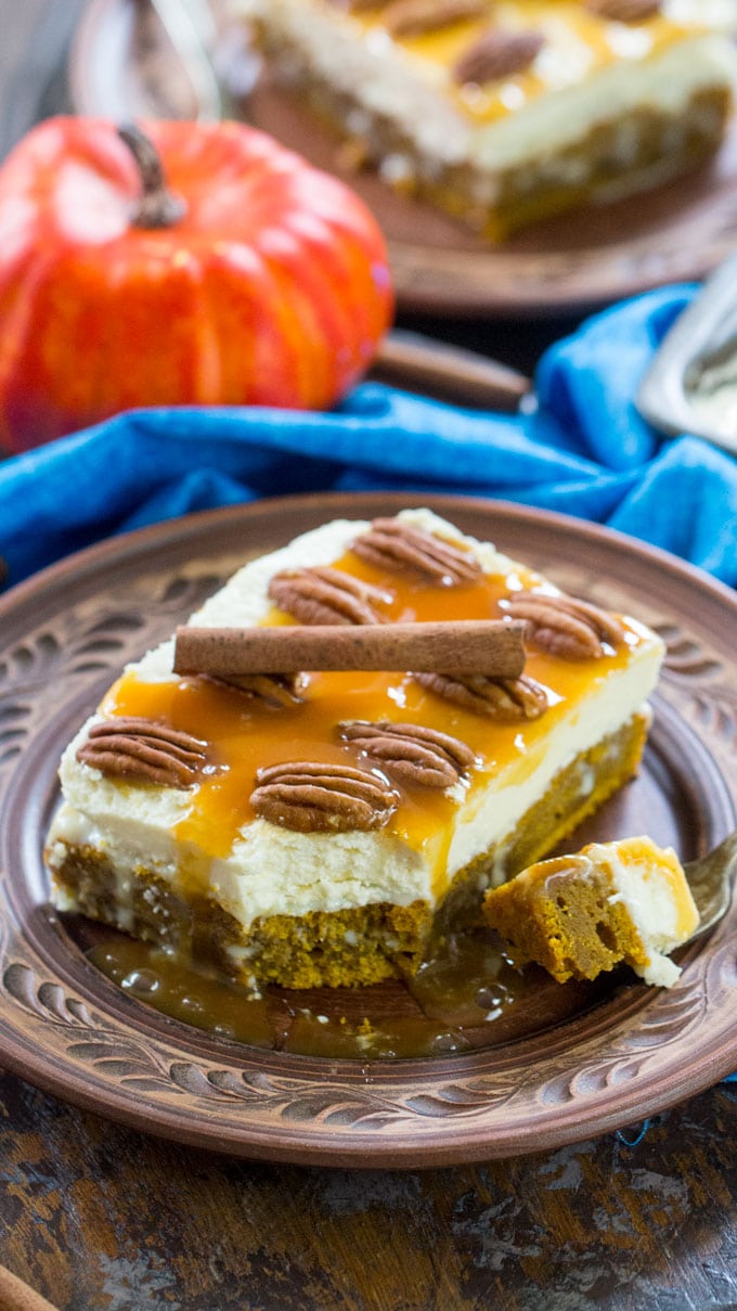 White chocolate pumpkin poke cake with caramel sauce served on a silver plate