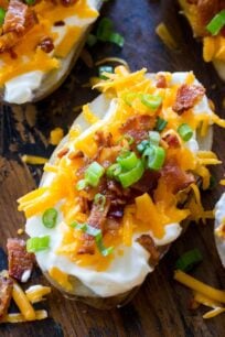 Easy Slow Cooker Baked Potatoes are the perfect side dish that you can make in your slow cooker year around. Seriously, its the easiest recipe you will ever make!