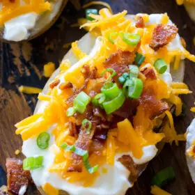 Easy Slow Cooker Baked Potatoes are the perfect side dish that you can make in your slow cooker year around. Seriously, its the easiest recipe you will ever make!