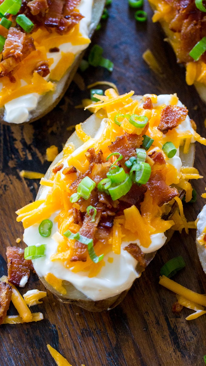 Easy Slow Cooker Baked Potatoes are the perfect side dish that you can make in your slow cooker year around. Seriously, its the easiest recipe you will ever make!