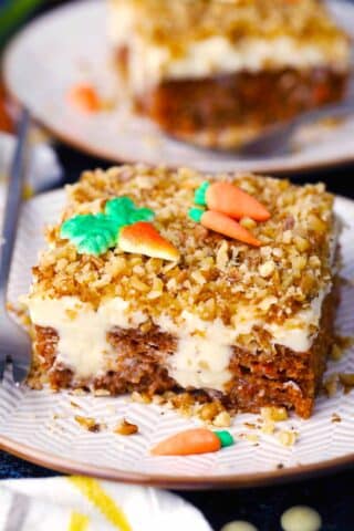 a slice of carrot cake poke cake on a plate