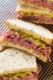 The real deal Corned Beef Sandwiches are the homemade take on the classic deli sandwiches of corned beef with toasted rye bread, sauerkraut and Russian dressing.