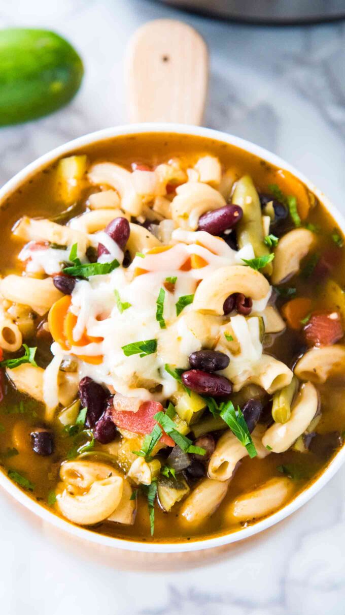 Image of instant pot minestrone soup garnished with cheese. 