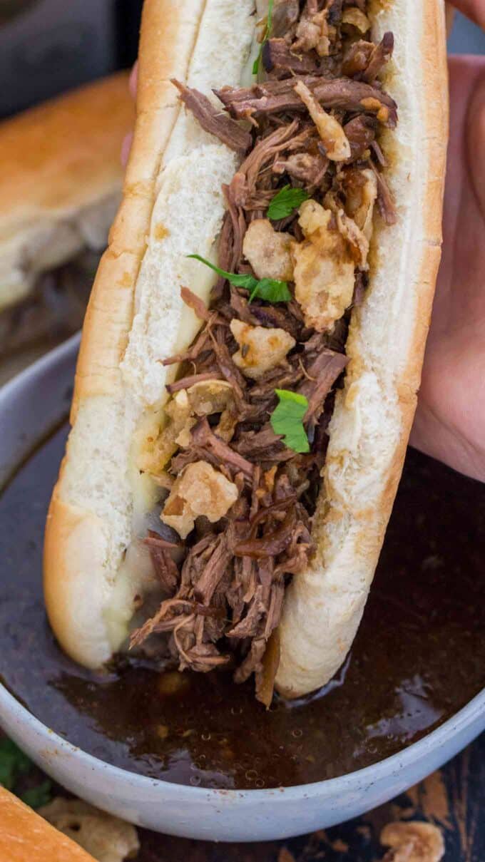 French Dip Sandwich dipped in au jus sauce