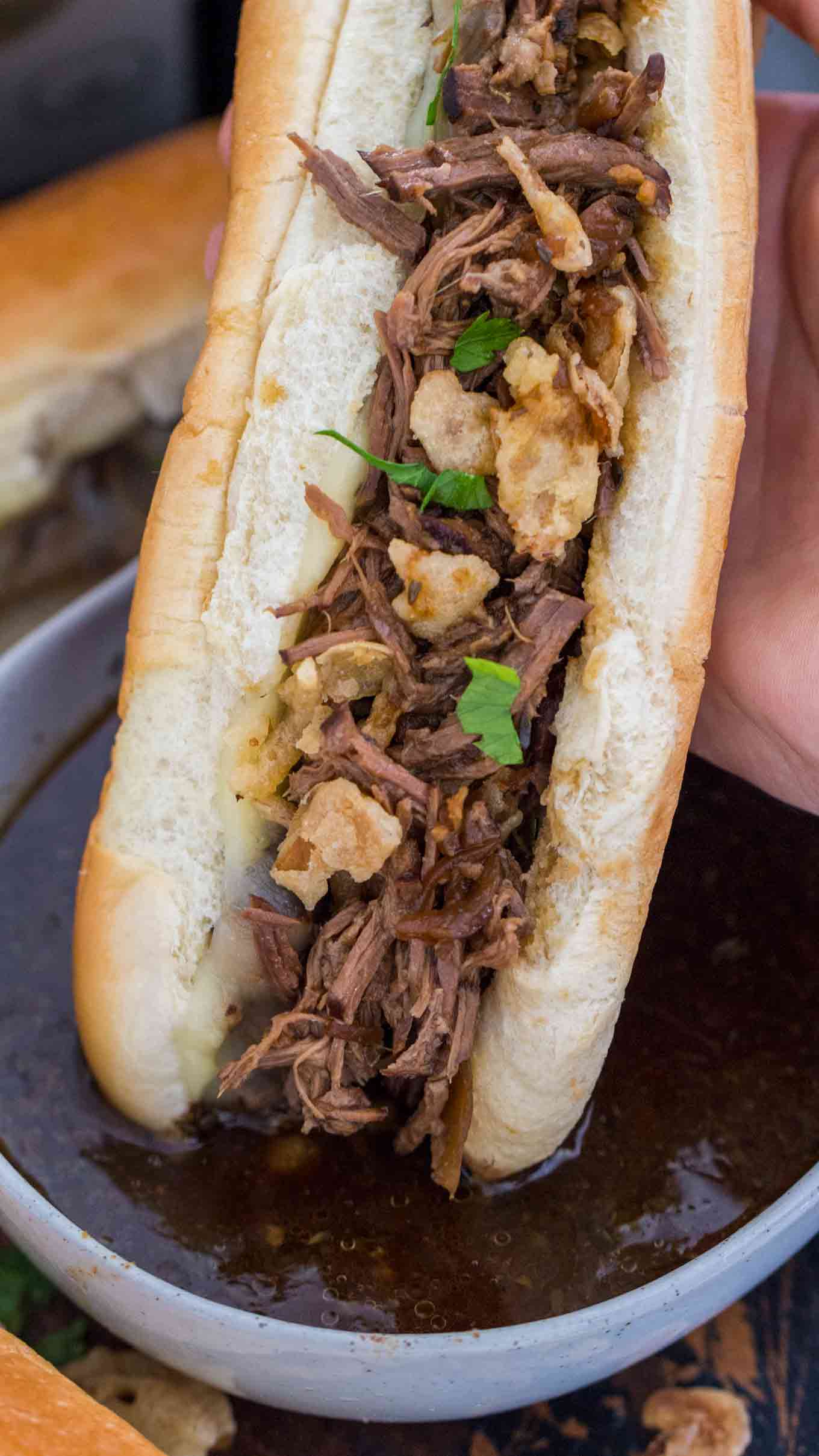Slow Cooker French Dip Sandwiches are incredibly juicy, tender and so flavorful. Perfect for a delicious dinner and the best quick and easy party food. #slowcooker #crockpot #sandwiches #beefrecipes #easyrecipes #sweetandsavorymeals Slow Cooker French Dip Sandwiches