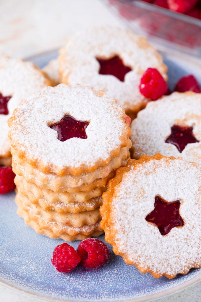 A stack of homemade raspberry Linzer cookies.