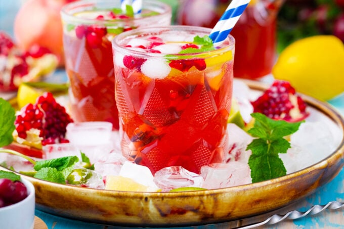 A platter of ice with cranberry mocktails.