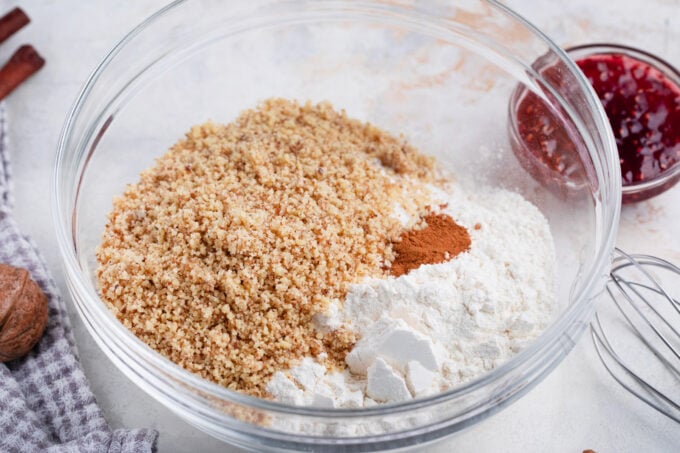 Adding walnuts to the dough for raspberry Linzer cookies.