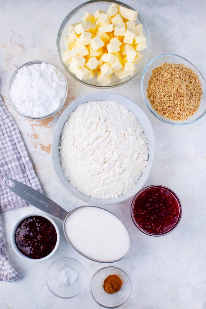 Eggless raspberry Linzer cookies ingredients in bowls.