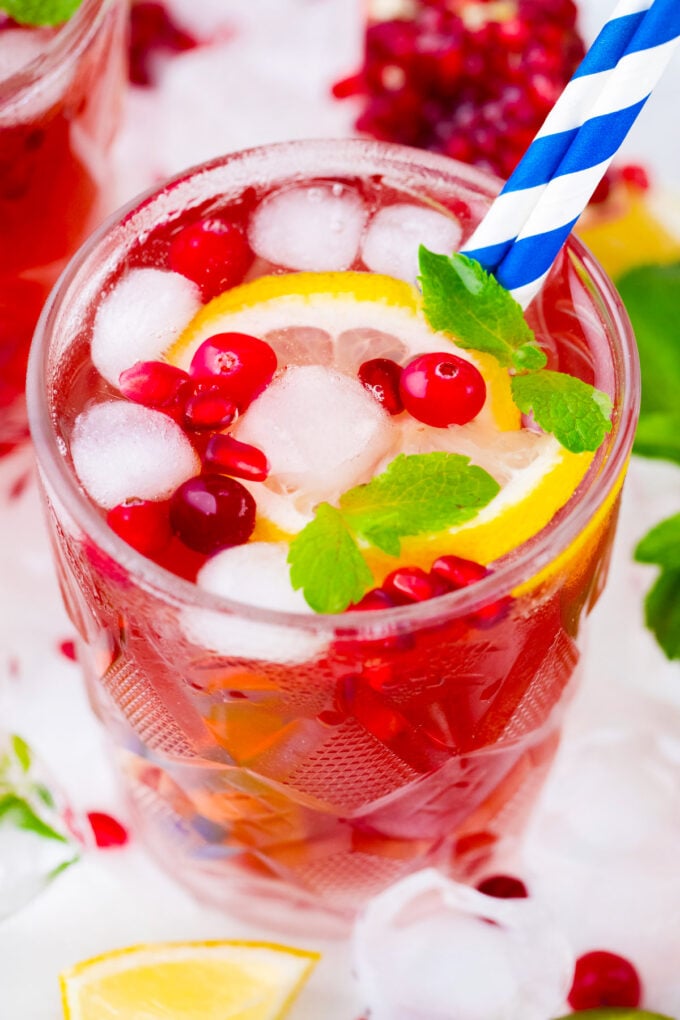 Overhead shot of cranberry mocktail with fresh cranberries.
