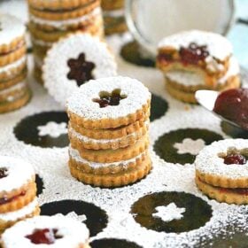 Eggless Walnut Raspberry Linzer Cookies are tender, buttery and sweet. They melt in your mouth and have a light nutty flavor and a delicious raspberry preserves middle.