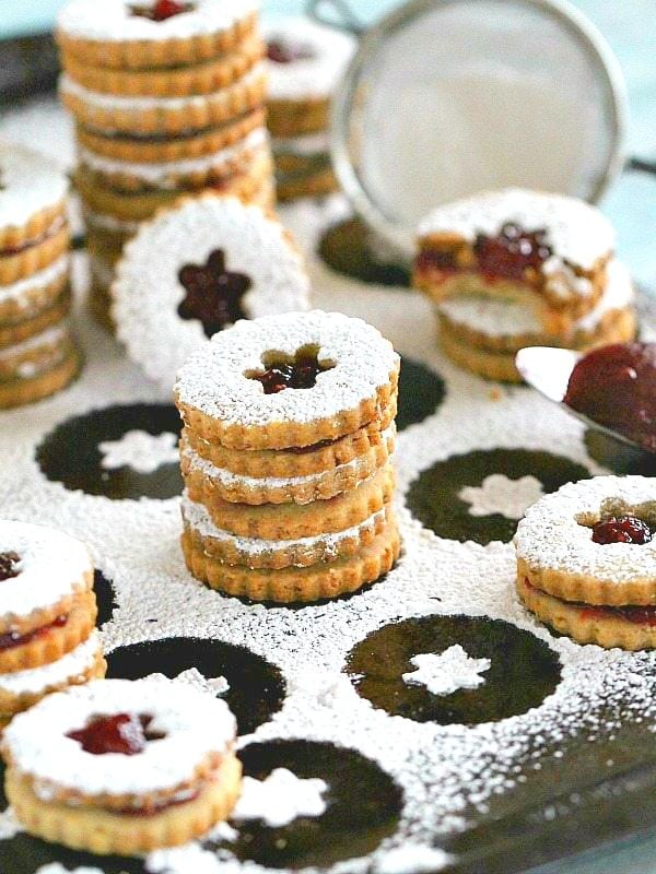 Eggless Walnut Raspberry Linzer Cookies are tender, buttery and sweet. They melt in your mouth and have a light nutty flavor and a delicious raspberry preserves middle.