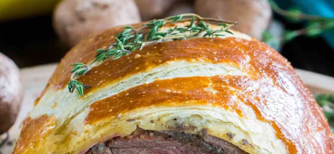 Beef Wellington cooked perfectly while wrapped in puff pastry, ham and the most amazing mushroom duxelles made with cognac duck mousse.