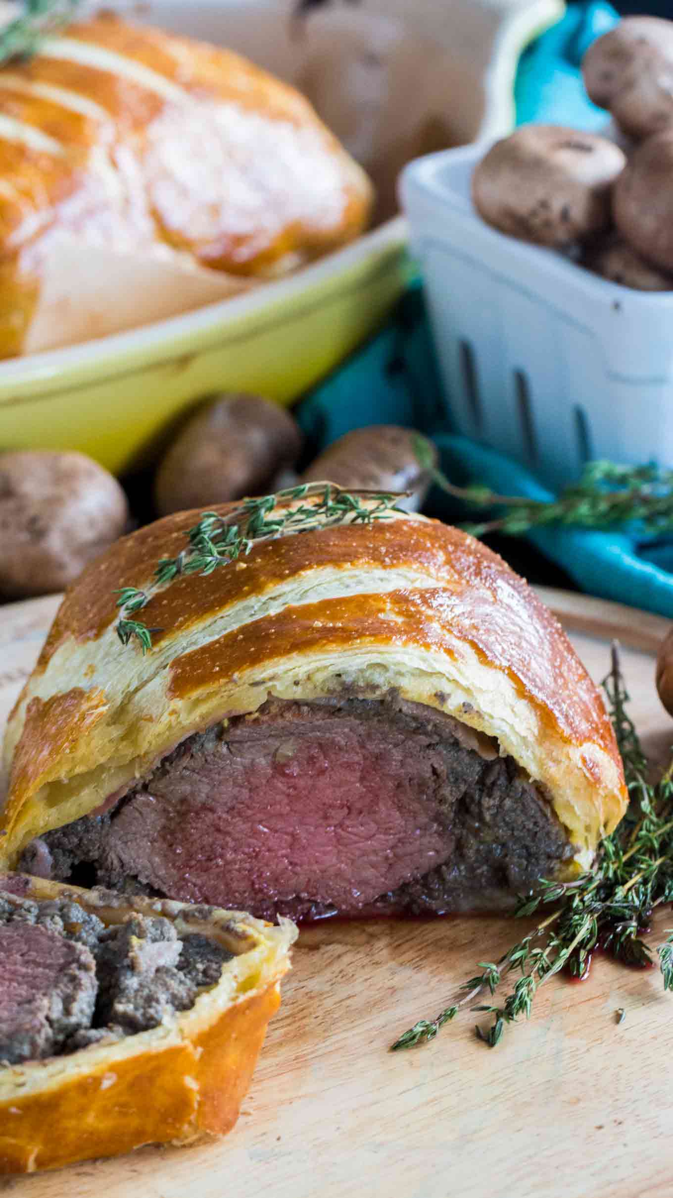 Perfect Beef Wellington cooked perfectly while wrapped in puff pastry, ham and the most amazing mushroom duxelles made with cognac duck liver mousse pate.