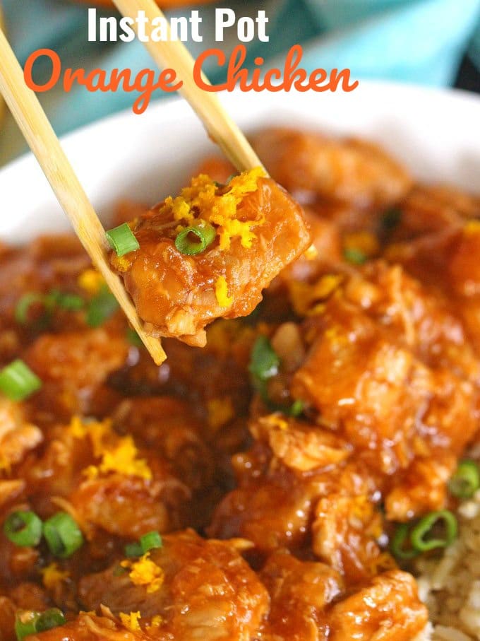 chopsticks holding a piece of instant pot orange chicken