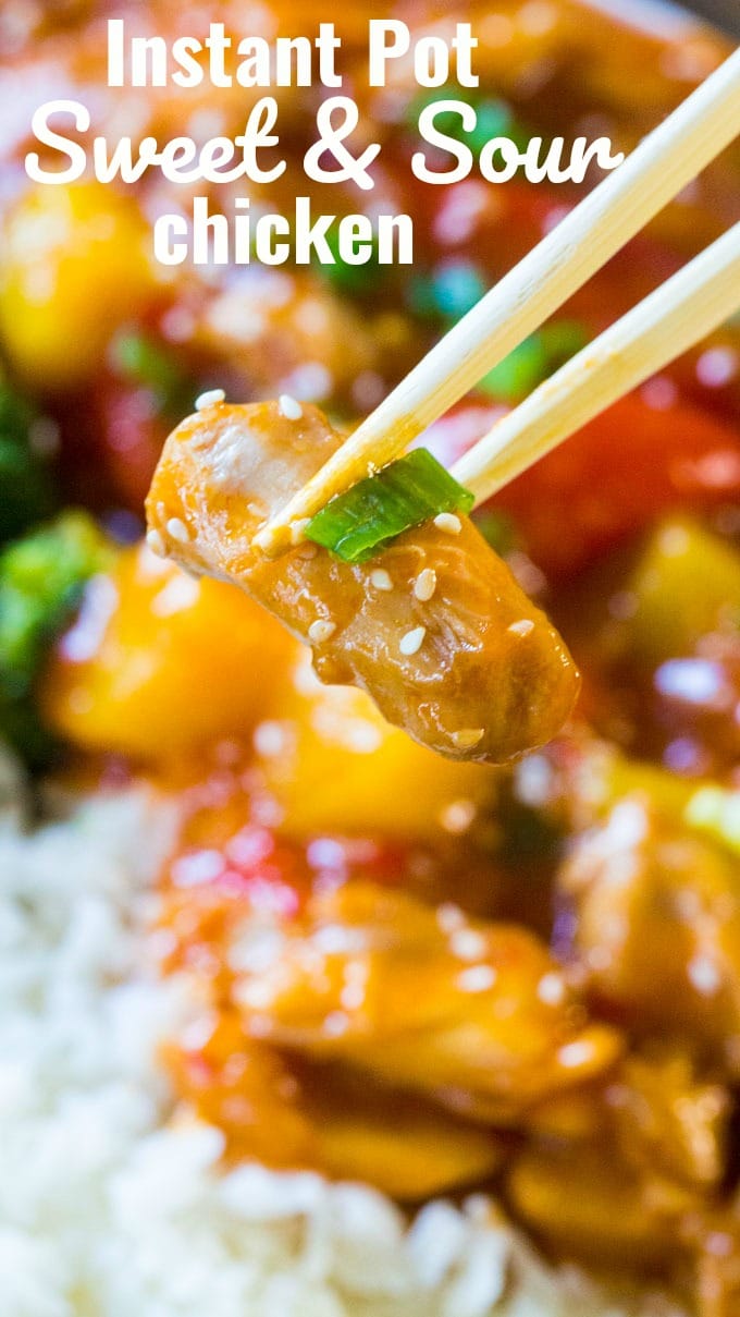 chopsticks holding a piece of instant pot sweet and sour chicken with sesame seeds. 