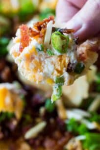 Million Dollar Dip is the best cheese dip that you can make! Layers of creamy cheese, sharp cheddar cheese, bacon, slivered almonds and green onions!