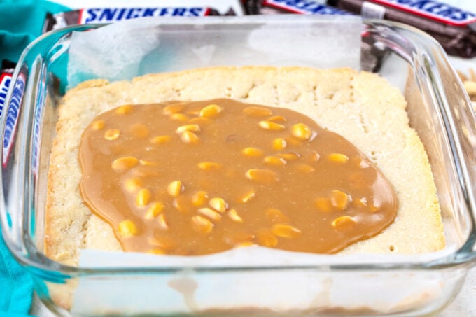 Adding caramel layer over shortbread layer.