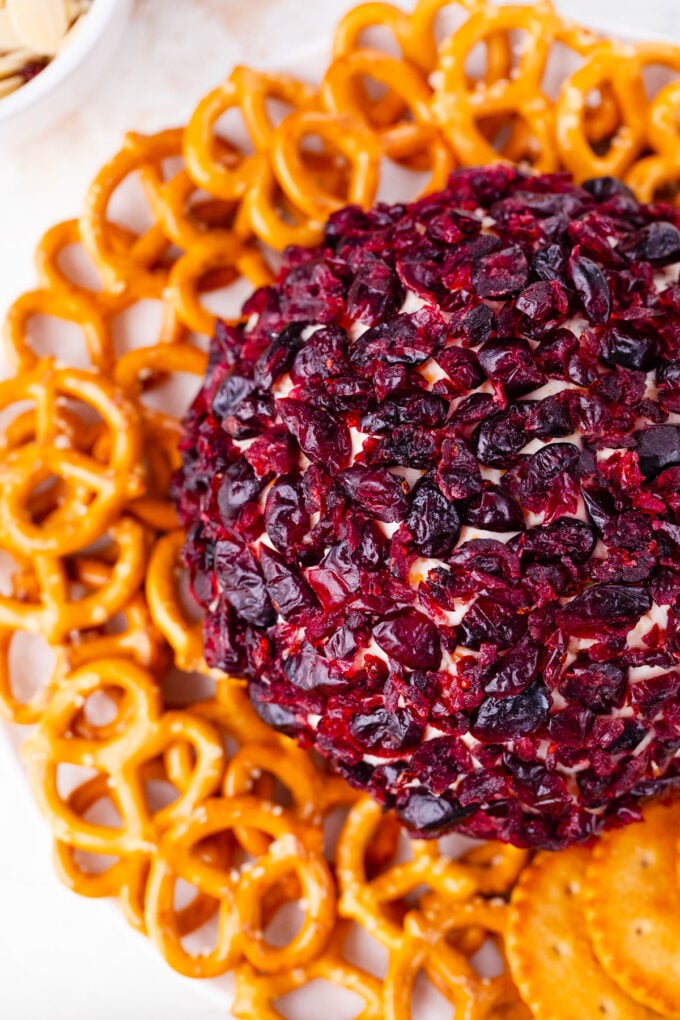 Overhead shot of bacon and cheese cheese ball covered in cranberries.