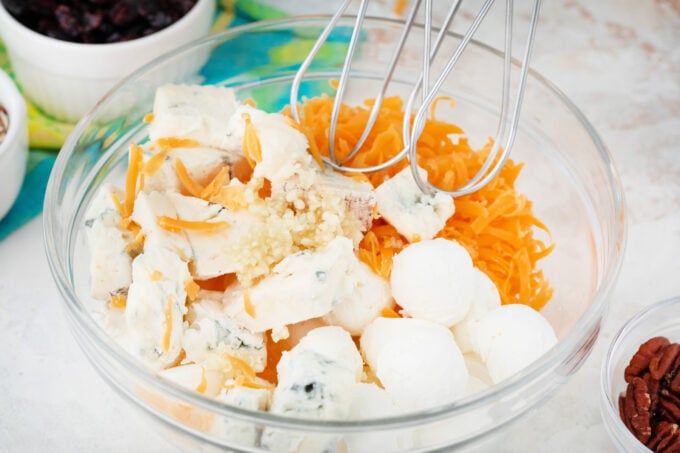 Beating cream cheese and cheese to make bacon and cheese cheese ball.