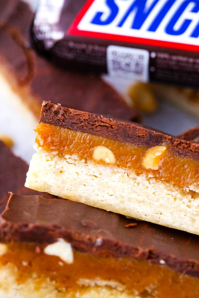 Homemade Snickers cookie bars topped with chocolate ganache.