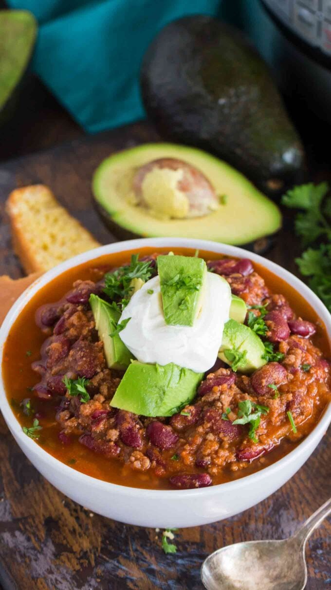 Instant pot chili bowl topped with sour cream and a slice of lime