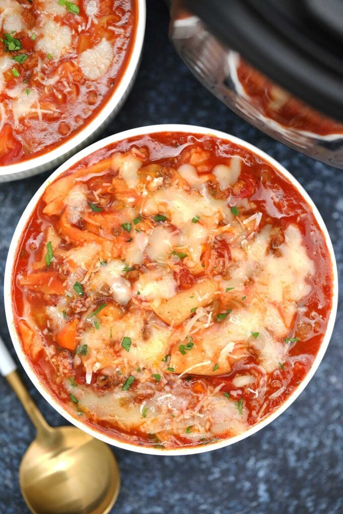 bowl of instant pot lasagna soup topped with cheese