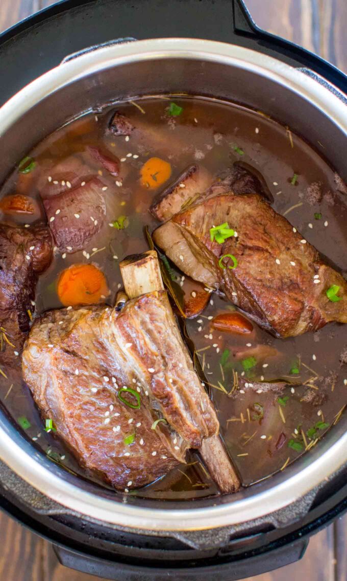 Image of pressure cooker short ribs with carrots and sesame seeds.