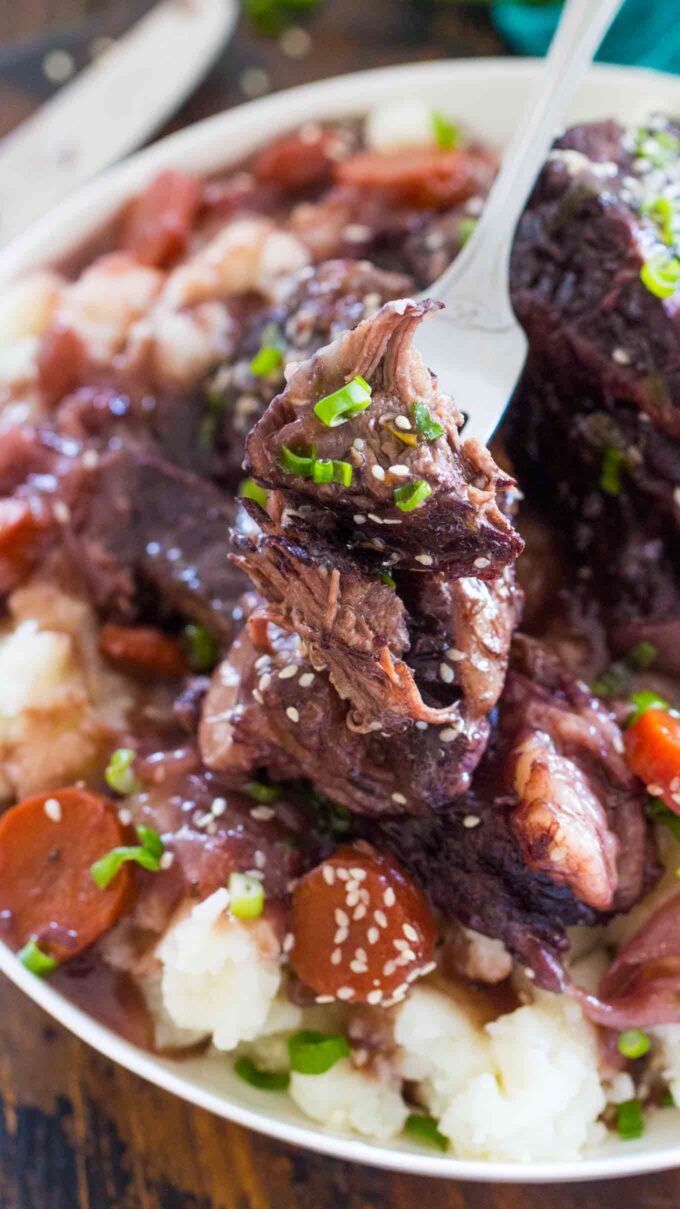 Image of short ribs cooked in the instant pot with mashed potatoes and carrots.