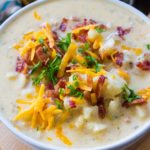 Creamiest Slow Cooker Baked Potato Soup is comforting, budget friendly and also very easy to make! Perfect for a weeknight meal.
