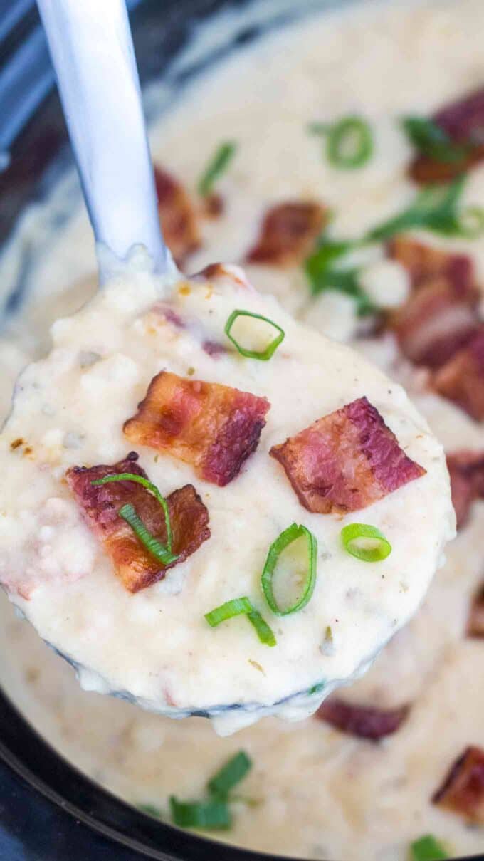 slow cooker baked potato soup topped with bacon and chopped green onion