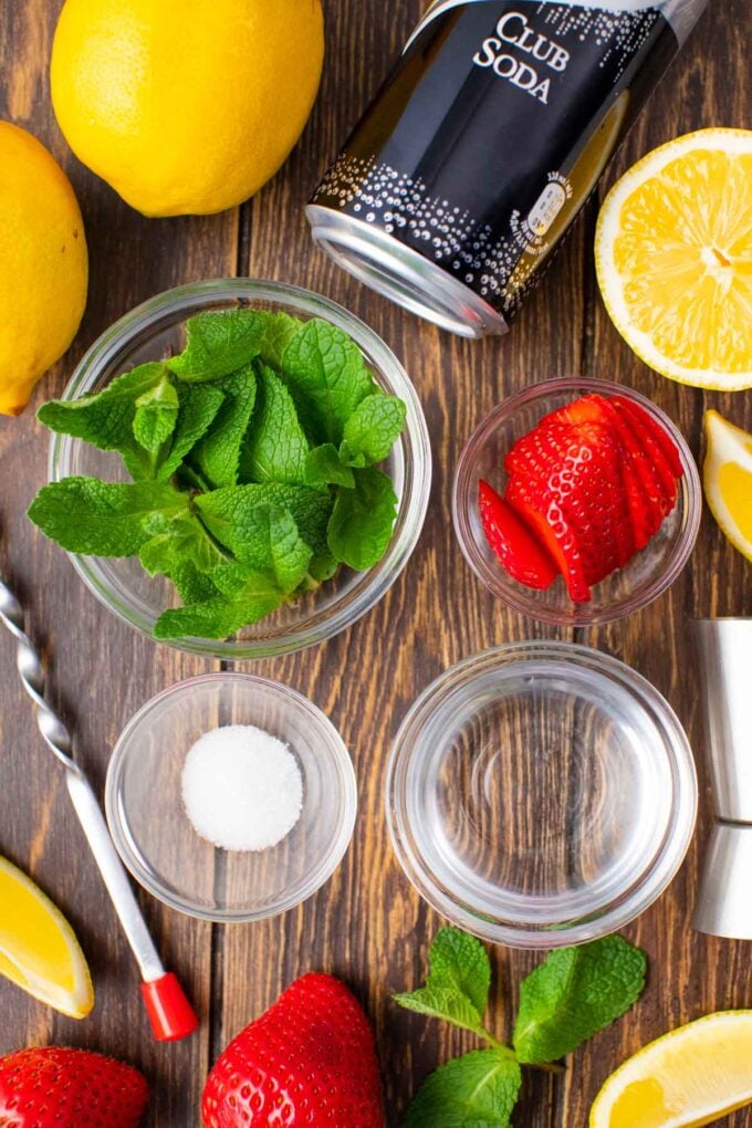 strawberry lemonade vodka club soda ingredients in bowls on a table