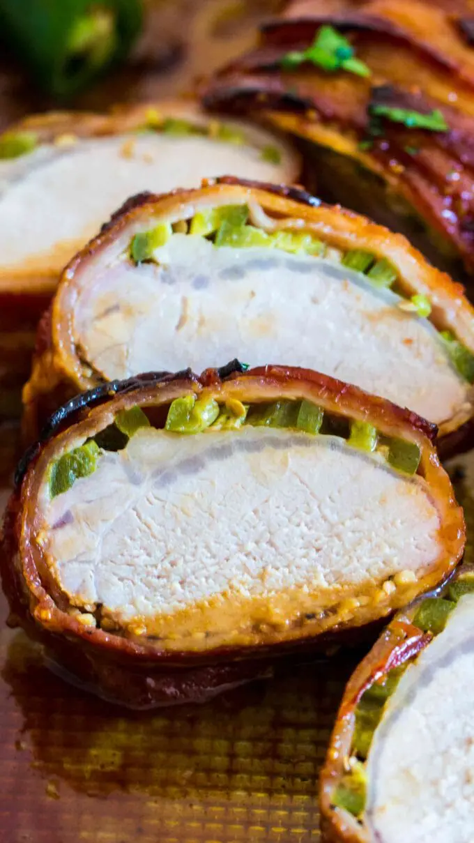 Photo of pork tenderloin and jalapeno wrapped in bacon.