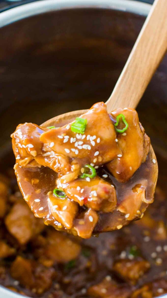 a large wooden spoon with Instant pot garlic sesame chicken