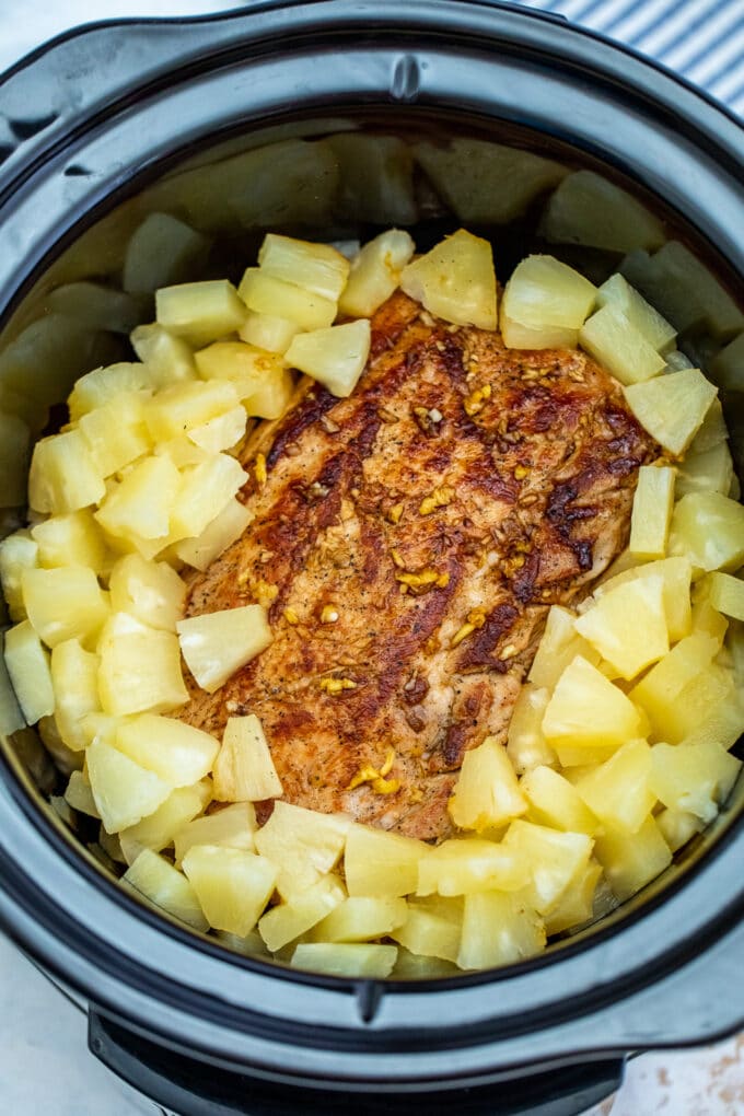 seared pork loin with pineapple chunks in the slow cooker