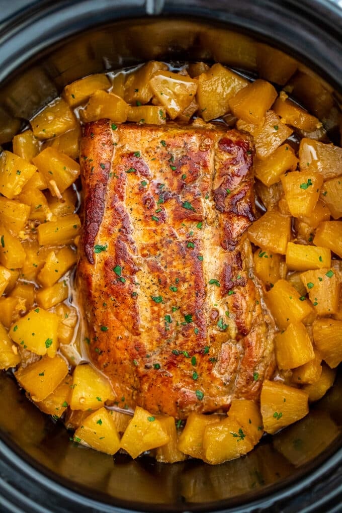 golden brown Slow cooker pineapple pork loin with pineapple chunks in the slow cooker