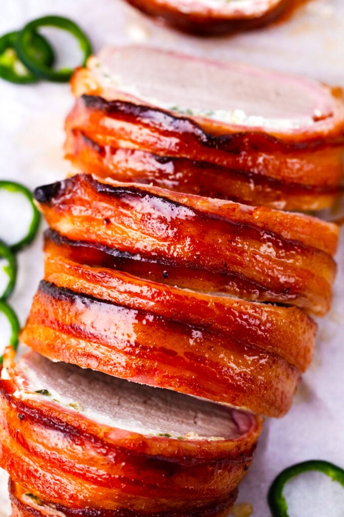 Overhead shot of crispy, glazed bacon wrapped pork tenderloin with cream cheese.