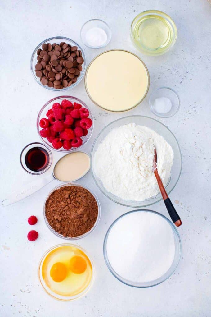 chocolate baileys poke cake ingredients in bowls on a table