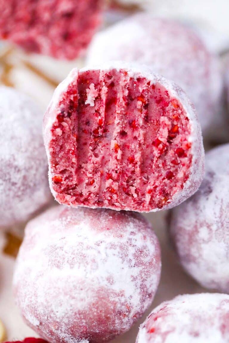 white chocolate raspberry truffles sliced in half revealing electric pink interior