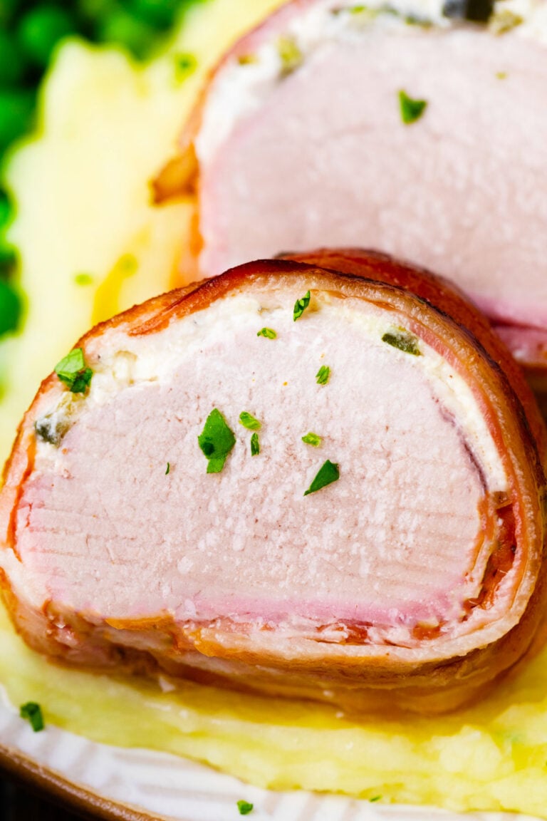 Close shot of bacon wrapped pork tenderloin with cream cheese.