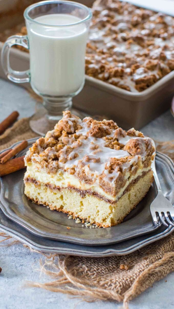 picture of freshly baked coffee cake with cinnamon filling on a silver plate next to a cup of milk