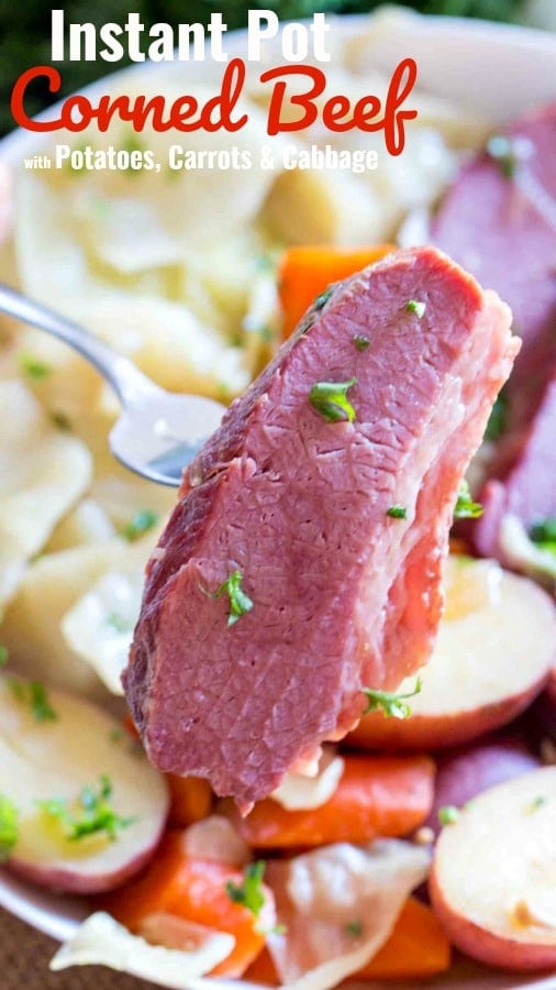 a folk holding tender Corned beef cooked in the instant pot