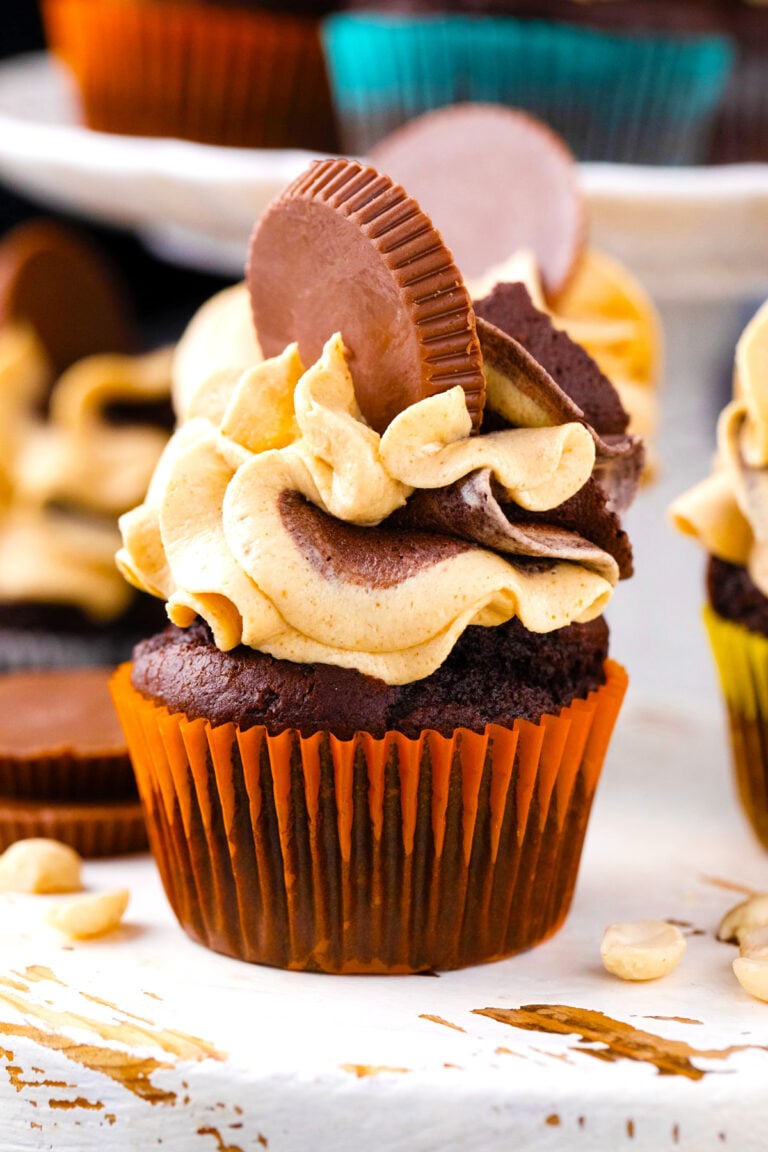 Homemade dark chocolate peanut butter cupcakes topped with peanut butter cups.