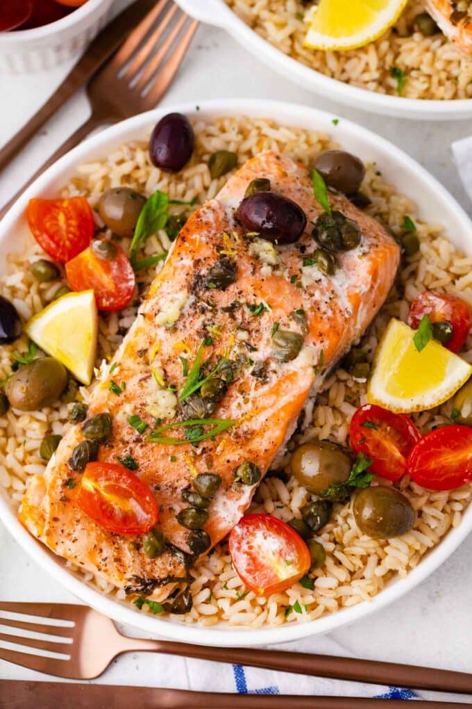 Mediterranean salmon foil packets served on top of rice with veggies