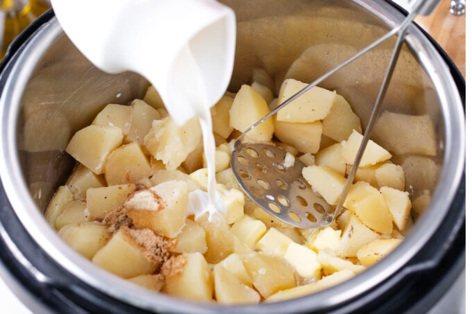 Adding cream to Instant Pot mashed potatoes.