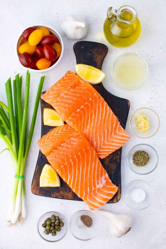 Mediterranean salmon foil packets ingredients in bowls on a table