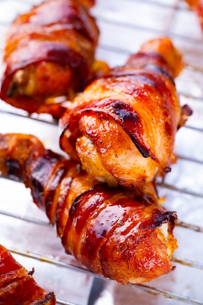 Crunchy brown sugar bacon wrapped chicken drumsticks.