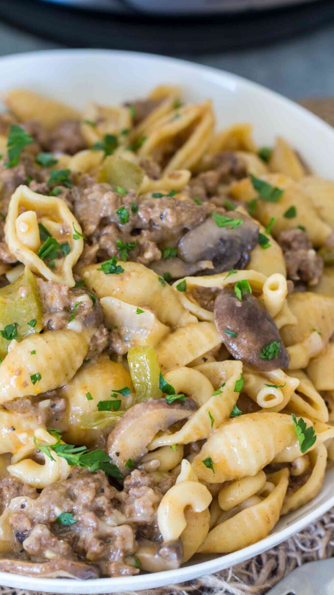 philly cheesesteak pasta on a plate garnished with chopped parsley