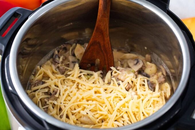 stirring shredded cheese into instant pot philly cheesesteak pasta